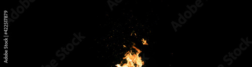 Big fire and silhouette of brazier on black background. Flame of fire in dark. Bonfire in barbecue at night. Dance of flame. Form of blaze