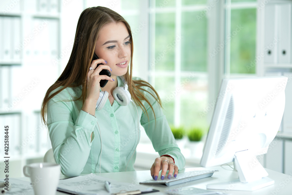 Portrait of businesswoman working in office talking on smartphone Portrait of businesswoman working in office talking on smartphone