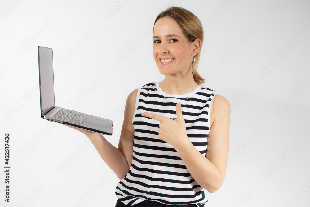 Young casual woman holding a laptop computer isolated over white background. Young casual woman holding a laptop computer isolated over white background.