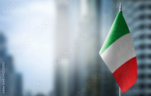 Fotografie A small flag of Italy on the background of a blurred background