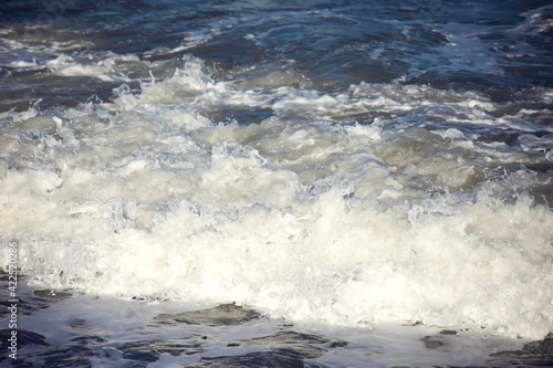 Sea waves and foam of Mediterranean sea with strong wind, Spain,