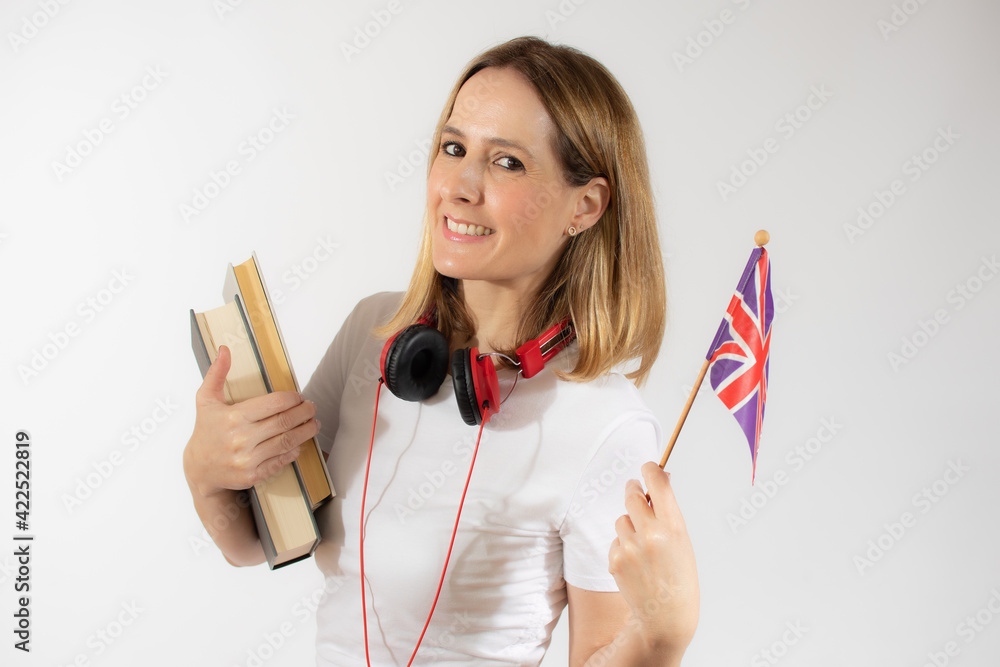 Portrait of a smiling casual young woman with backpack holding books and british flag isolated over white background Portrait of a smiling casual young woman with backpack holding books and british flag isolated over white background