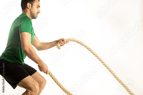 athlete man training with gym ropes on white background