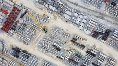 Aerial view of Heavy equipment parts in construction New industrial factory. Raw industrial material in cargo port at industrial estate for import export around in the world