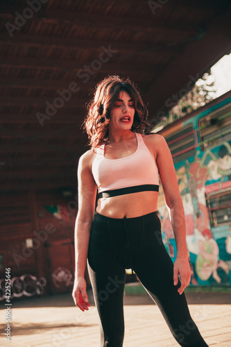 portrait of young athletic and charming girl during a moment of morning workout