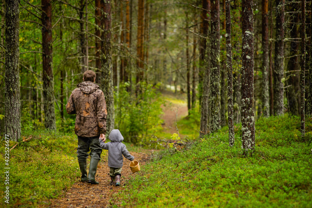a man with his son in walking in the woods, selective focus