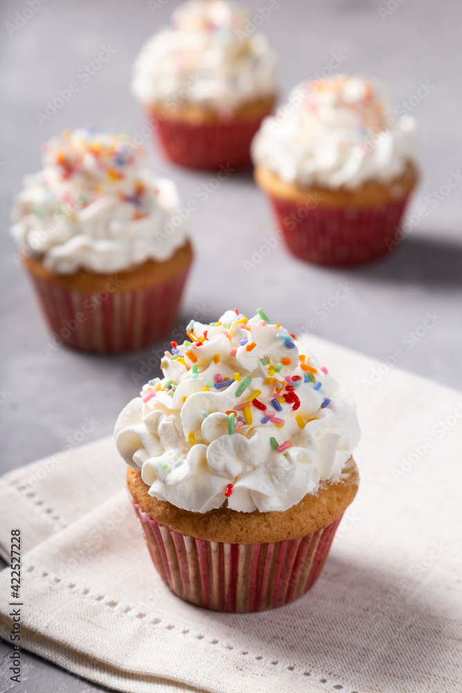 Tasty party cupcakes on the table. Cupcakes with whipped cream. Tasty party cupcakes on the table. Cupcakes with whipped cream.
