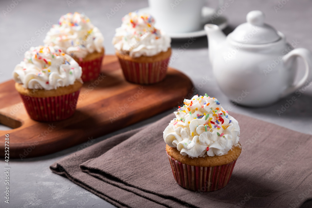 Tasty party cupcakes on the table. Cupcakes with whipped cream. Tasty party cupcakes on the table. Cupcakes with whipped cream.