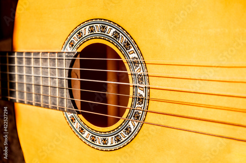 Close-up of vibrating acoustic guitar strings. closeup shot of guitar and strings with shallow depth of field. soft focus. photo