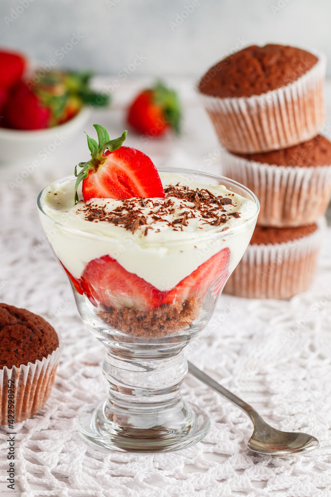 Trifle. Layered Dessert of chocolate sponge cake, whipped cream or ricotta and fresh strawberries in a glass bowl. Delicious gourmet breakfast. Selective Focus Trifle. Layered Dessert of chocolate sponge cake, whipped cream or ricotta and fresh strawberries in a glass bowl. Delicious gourmet breakfast. Selective Focus