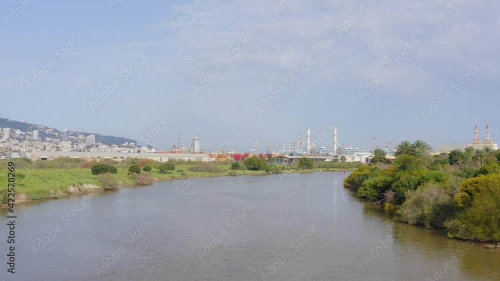 Haifa Kishon river stream with the city port in the horizon, Aerial view. Haifa Kishon river stream with the city port in the horizon, Aerial view.