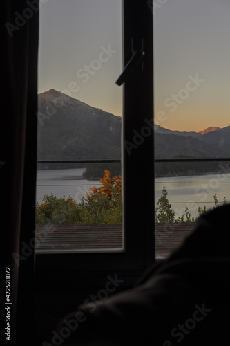 sunset landscape with lake and mountains from windows © Florencia
