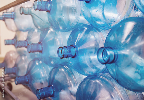 Empty bottles are stacked in a row. Cleaning of plastics in the production of pure water