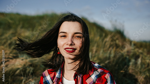 girl in a red skirt enjoys the summer in the field