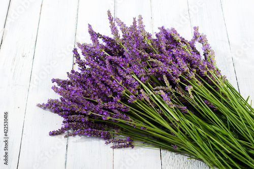 purple lavender flowers heap on faded white wooden table background