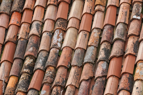 old and new clay roof tiles on the roof © Marcin Rogozinski