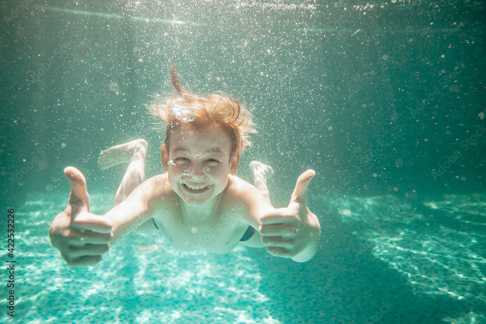 Cute little boy underwater in swimming pool Stock Photo | Adobe Stock