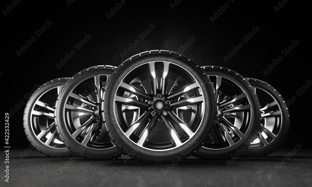 Five car wheels on asphalt and black background. Poster or cover design. 3D rendering illustration.