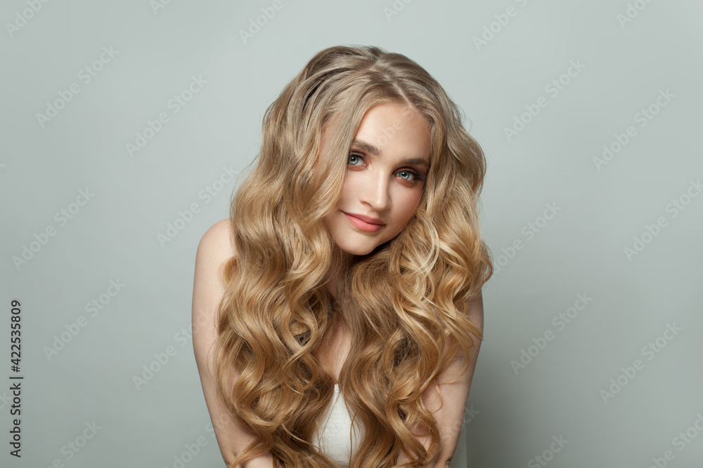 Lovely woman with long perfect blonde hair on white background