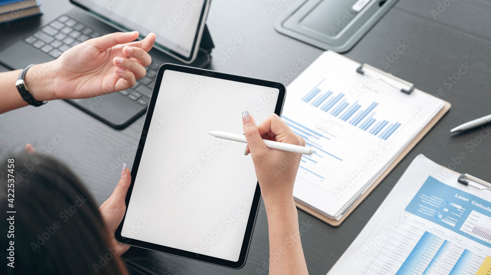 business people discussing and working on tablet with digital pen, blank screen for graphic design. business people discussing and working on tablet with digital pen, blank screen for graphic design.
