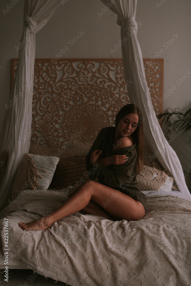 Fototapeta premium Young woman in the bedroom