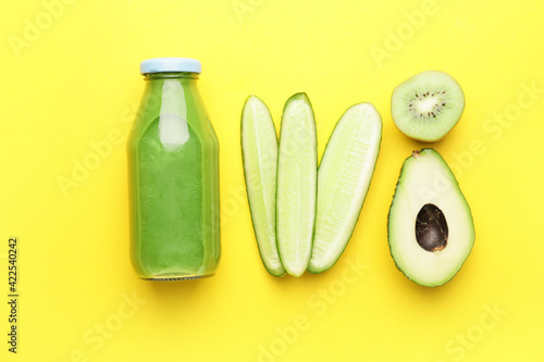 Composition with bottle of healthy green smoothie and ingredients on color background