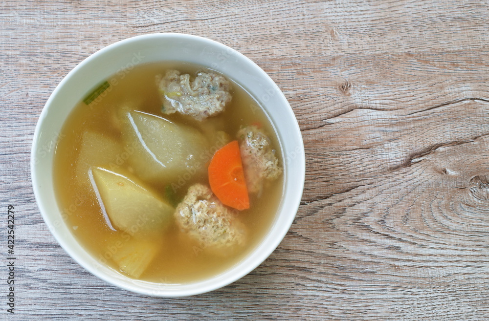 boiled winter melon with chop chicken and slice carrot soup in bowl on table boiled winter melon with chop chicken and slice carrot soup in bowl on table