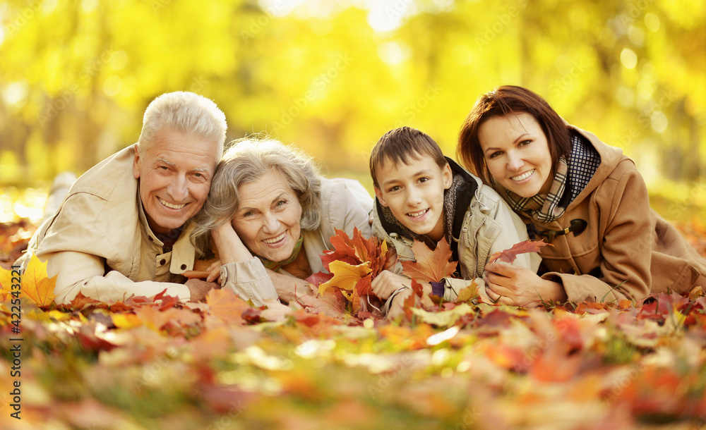 Fototapeta premium Happy family relaxing in autumn forest
