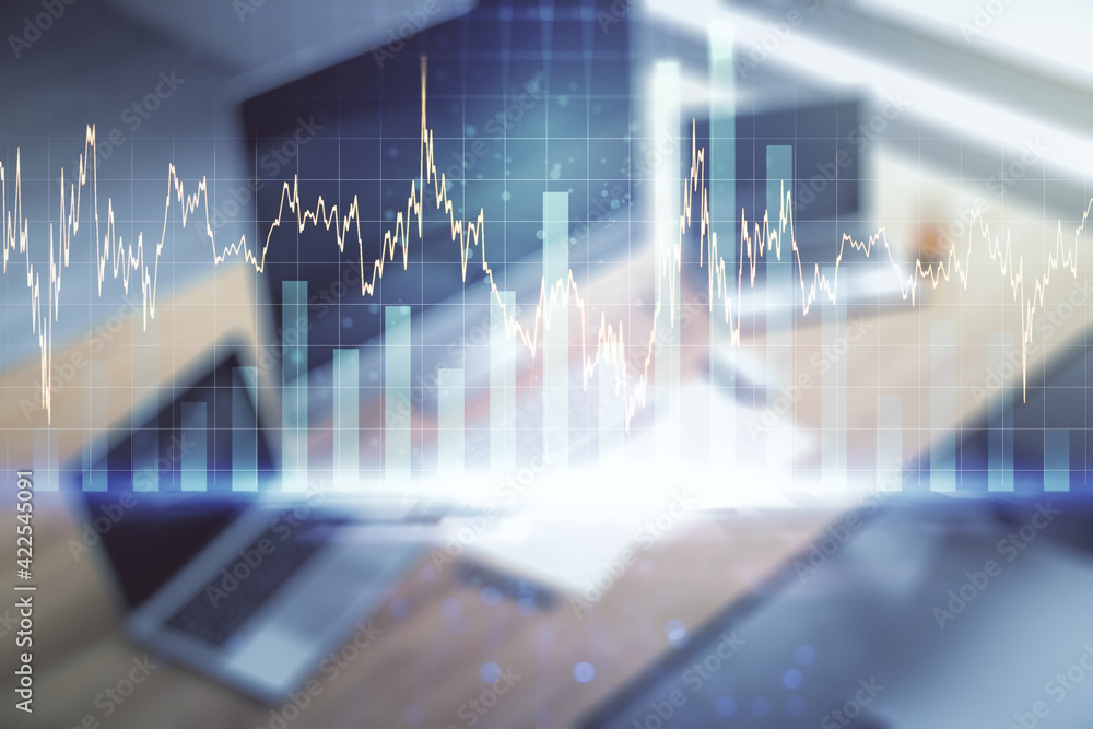 Double exposure of abstract creative financial chart and modern desktop with laptop on background, research and strategy concept