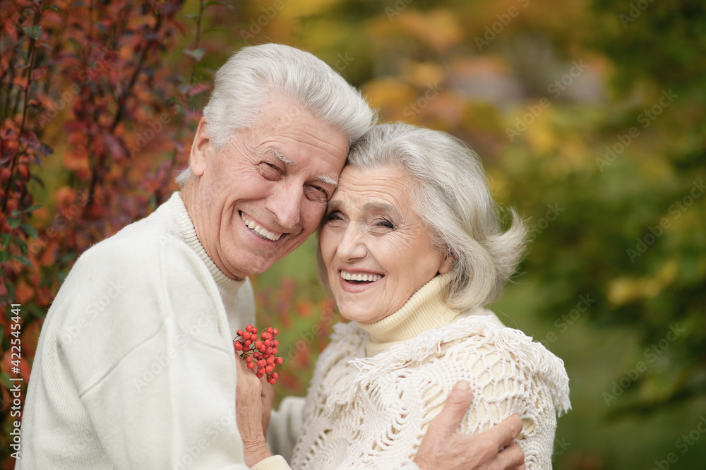 portrait of beautiful senior couple with rowan in the park portrait of beautiful senior couple with rowan in the park