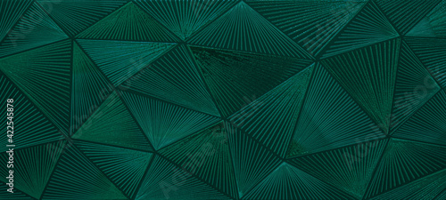 Abstract triangular dark green mosaic tile wallpaper texture with geometric fluted triangles background banner photo