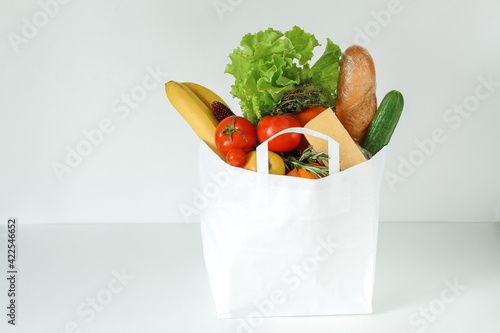food supply, food delivery by a volotner from the market, a paper bag with purchases. copy of the space