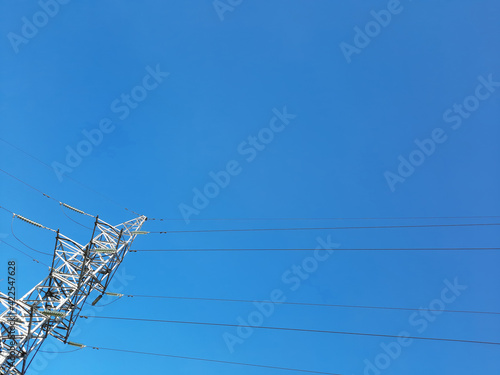 High voltage pillar against blue sky
