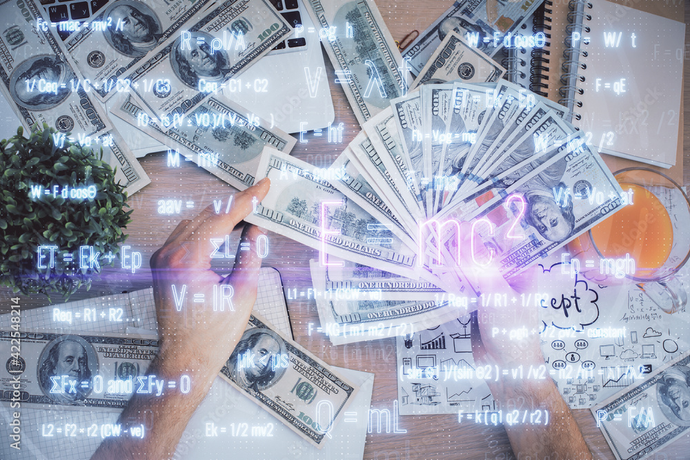 Multi exposure of Formulas drawing hologram and USA dollars bills and man hands. Education Multi exposure of Formulas drawing hologram and USA dollars bills and man hands. Education