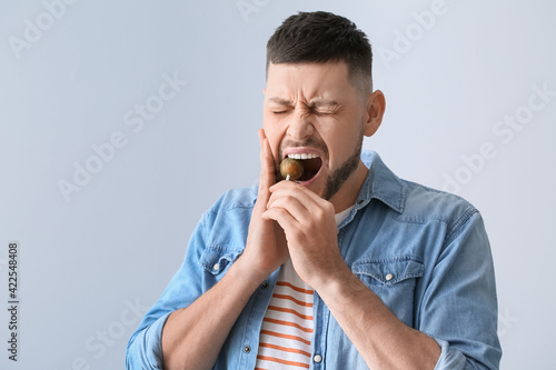 Man with sensitive teeth an...
