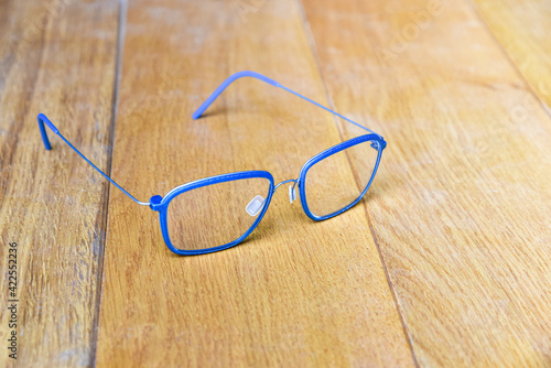 Clear eyeglasses, Glasses blue frame with wire strip modern style on wood background