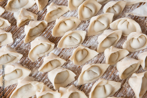 Raw dumplings background. Cooking dumplings in the kitchen.