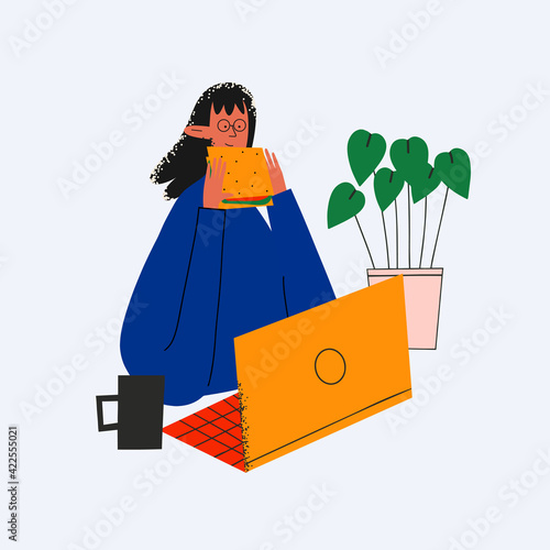 ethnic business woman having a snack at work in front of the computer. Time out for coffee while studying. Deadline at work. Fast food Sandwich, lunch in the office. Irregular routine. Trendy flat 
