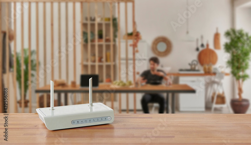 Modem and router box on the table and living room background blur concept. photo