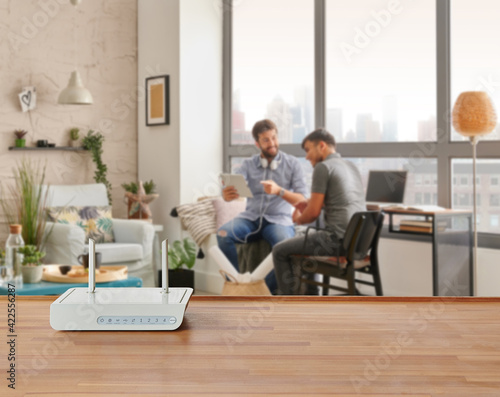 Modem and router box on the table and living room background blur concept.