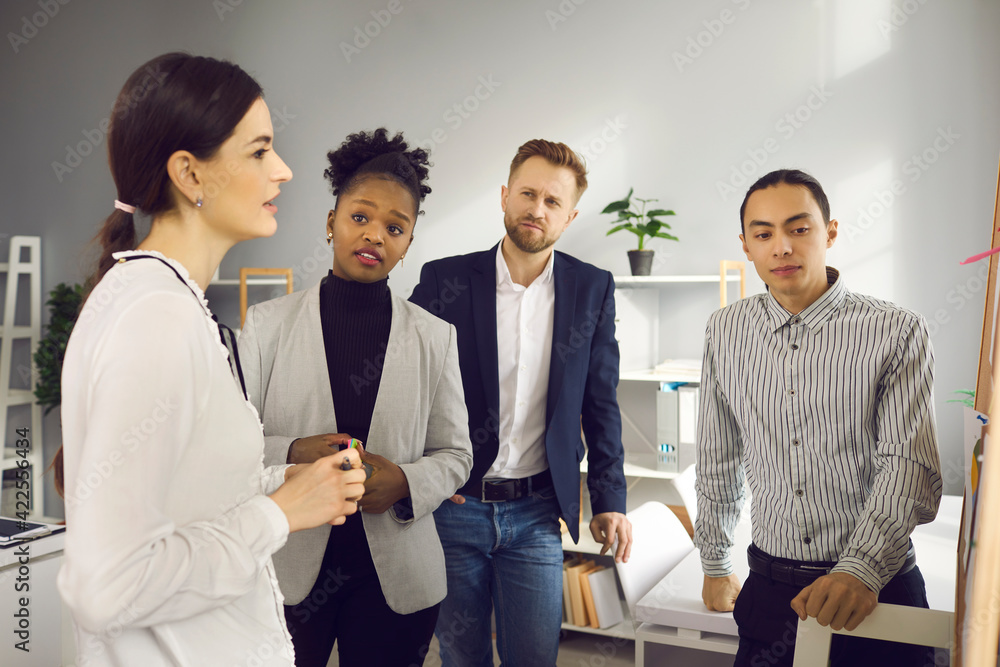 Multiracial people looking for business solution, brainstorming and discussing ideas in group meeting. Team of young office workers analyzing results of teamwork and listening to each other's opinion Multiracial people looking for business solution, brainstorming and discussing ideas in group meeting. Team of young office workers analyzing results of teamwork and listening to each other's opinion