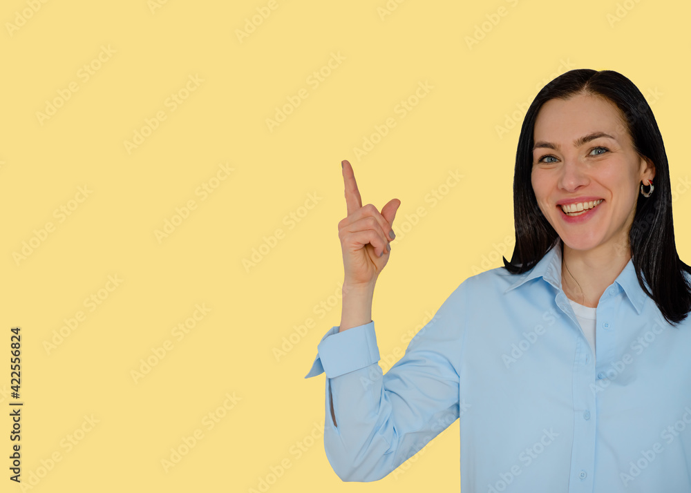 smiling woman in blue shirt showing ok sign against yellow background smiling woman in blue shirt showing ok sign against yellow background
