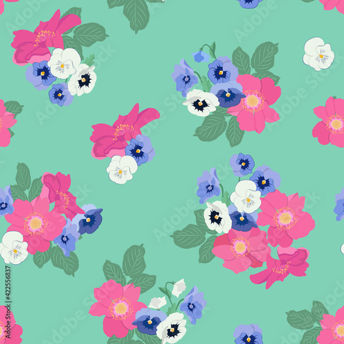 Seamless vector illustration with flowers of wild rose and pansies on a green background.