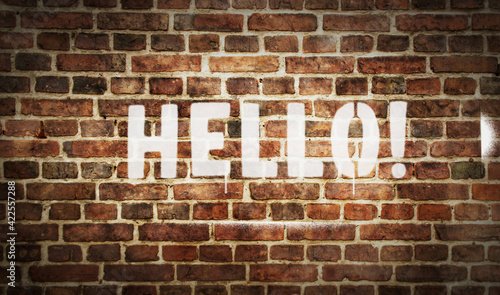 Hello sign spray painted on the brick wall