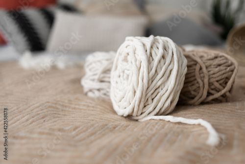 Roll of macrame rope. White and gray thread on a beautiful pastel background.