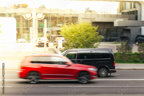 city traffic , red and black car 