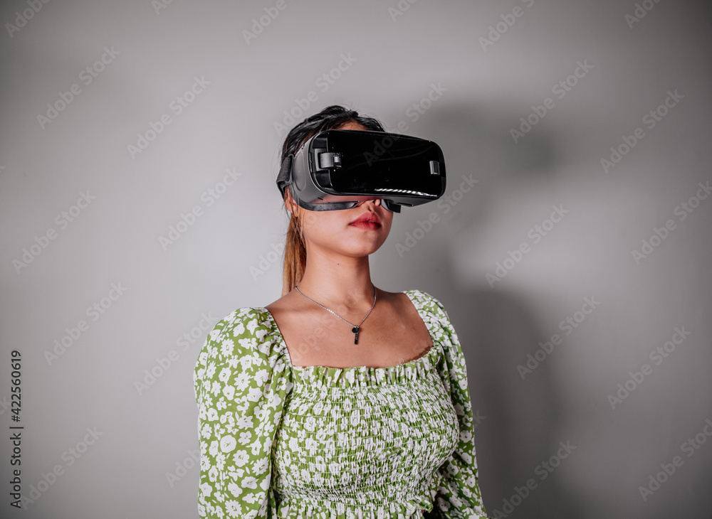 Asian Woman looking through virtual reality device at home. Augmented reality, game, future technology concept.VR Asian Woman looking through virtual reality device at home. Augmented reality, game, future technology concept.VR