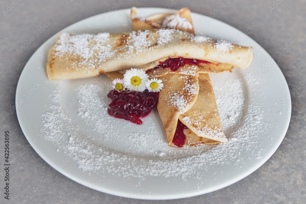 delicious pancakes with cranberries and powder sugar