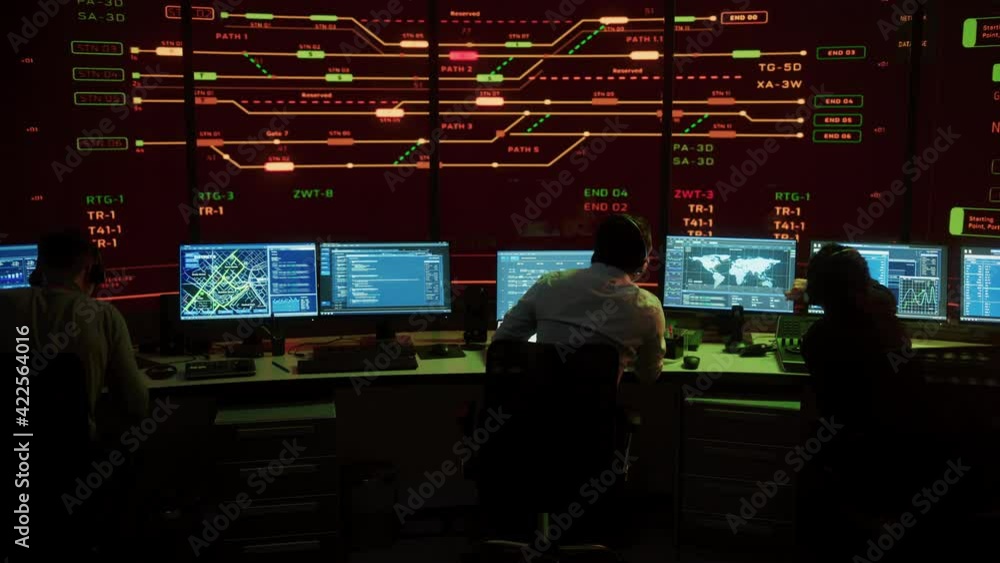 Professional IT Technical Support Specialists and Software Developer Working on Computers in Monitoring Control Room with Digital Screens with Server Data, Blockchain Network and Surveillance Maps. Professional IT Technical Support Specialists and Software Developer Working on Computers in Monitoring Control Room with Digital Screens with Server Data, Blockchain Network and Surveillance Maps.