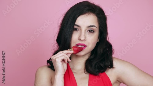 Cinematic footage of a beautiful young woman with fit body posining and dancing in studio photo